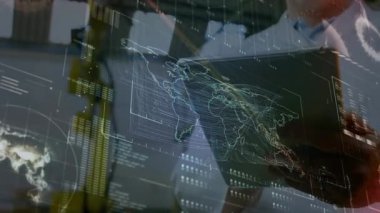 Adult man initiating map with data overlays by raising hand and tapping tablet for data analysis. Holography, data visualization, digital interface, technology, analytics, interface design, futuristic