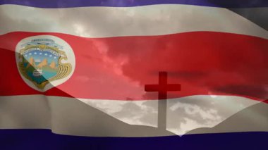 Rüzgar yükseliyor, bayrak mavi kırmızı şeritler tepe haçı üzerinde dalgalanıyor, ibiğin hareketi birliği simgeliyor. Vatanseverlik, sembolizm, kumaş, hareket, manzara, dinginlik, milliyet