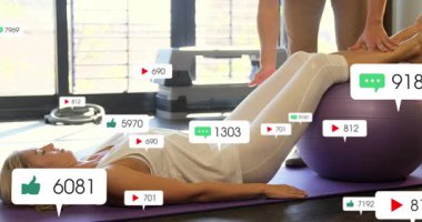 Beden eğitimi koçu, sosyal ölçümler canlandırılırken bacaklarının altına mor top yerleştiriyor. Egzersiz, eğitim, sağlık, minimalist, sağlık, güç, ev