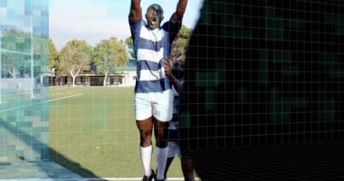 Rugby takım arkadaşları sahada çizgi kaldırma hareketi yaparken eğitim ızgarası da izleme hareketinde kaydırma yapıyor. Spor, takım çalışması, fitness, dijital, analiz, eğitim, atletizm