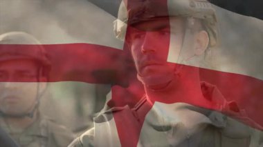 Aziz George Haçı bayrağı sallanırken askerlerin askeri tatbikat sırasında dizildiklerini gösteriyor. Askeri, disiplin, yoldaşlık, dayanıklılık, yiğitlik, hazırlık, bağlılık