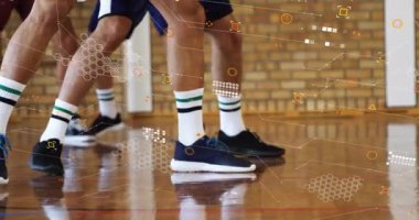 Sports player dribbling blue ball after defender shuffle faking accelerating toward hoop to score. Athletics, teamwork, dynamic, competition, movement, performance, energy