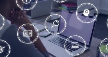 Dizüstü bilgisayara odaklanan olgun bir adam arama simgesinin ortaya çıkışını ve yüzen beyaz öğrenme simgelerini izliyor. Profesyonel, çalışma alanı, araştırma, analitik, dijital, eğitim, odaklanma