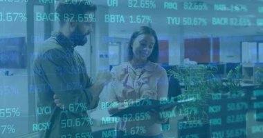 Woman tapping tablet screen showing financial figures updating for analysis while colleague nodding. Collaboration, analytics, digital, business, office, teamwork, technology