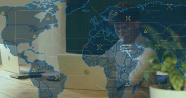 Man typing on laptop at desk initiating world map fading in and highlighting data analysis points. Technology, data, analytics, workspace, connectivity, innovation, modern