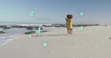 Çift, plaj dansını canlandırılmış veri simgeleriyle başlatarak sürdürülebilirliği canlandırıyor. Romantizm, uyum, koruma, açık hava, canlılık, hareket, çevre