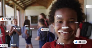 Boy in red shirt smiling and initiating floating social media notifications showing follower counts. Youth, education, outdoor, casual, connectivity, social, communication