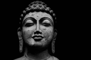 Buddha Face Statue Isolated On Black Background, Granite Buddha Statue Portrait.