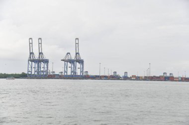 Kochi, Hindistan - 2 Eylül 2023: Cochin Limanı manzarası durgun. Lojistik ve ulaşım faaliyetleri. Hindistan 'ın Kerala kıyı eyaleti Kochi yakınlarındaki okyanusta hareket eden büyük bir konteyner gemisi..