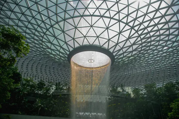 stock image World Largest Indoor Water Falls in Jewel Changi Airport - Singapore. Best Airport in the World. waterfall in rain forest Jewel Changi Airport Singapore.