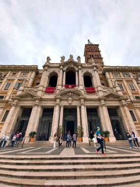 Roma, Lazio, İtalya. 13 Nisan 2025. Ziyaretçiler, barok mimarisi olan büyük bir Katolik kilisesi olan Santa Maria Maggiore Bazilikası 'nın girişinde toplandılar.