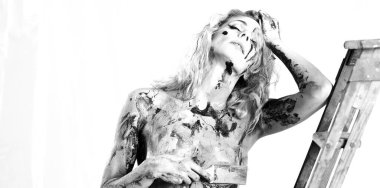 A young woman with a characteristic face is covered with colorful pain