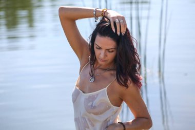 Portrait of a beautiful girl in a white wet shir