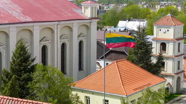 stock image The Lithuanian national flag, the tricolor, flutters in the wind in the old town of Kedainiai 04 29 202