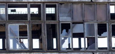 Abandoned industrial building, shattered windows, forgotten by people, an industrial reli clipart