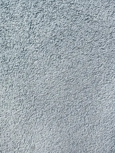 stock image close-up texture shot of a rough, grey surface reminiscent of concrete or stucco. The granular quality and uneven shade variation make it suitable for backgrounds, graphic design, or 3D modeling references.