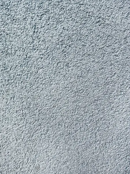 Stock image close-up texture shot of a rough, grey surface reminiscent of concrete or stucco. The granular quality and uneven shade variation make it suitable for backgrounds, graphic design, or 3D modeling references.