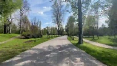 Güneşli bir bahar gününde parkta bir patika boyunca yürümenin zamanı..