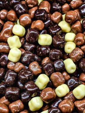 Assorted Chocolate Coated Caramel Cubes Dark, Milk, and White Chocolate Sweet Treat Macro Photography Delicious Dessert Snack for Kids and Adults Party Food Vibrant Confectionery Fun Theme 