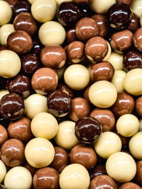 Assorted Chocolate Coated Caramel Cubes Dark, Milk, and White Chocolate Sweet Treat Macro Photography Delicious Dessert Snack for Kids and Adults Party Food Vibrant Confectionery Background 
