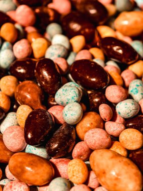 Assorted Chocolate Covered Nuts and Candy-Coated Chocolates Colorful Sweet Treat Macro Photography Delicious Dessert Snack for Kids and Adults Party Food Vibrant Confectionery Theme Holiday Background