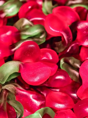Red and Green Gummy Candy Shaped Like Cherries Sweet Jelly Macro Photography Tasty Dessert Treat for Kids and Adults Party Snack Food Vibrant Confectionery Fun Theme Holiday Stock background 