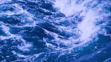 Yavaş Okyanus Dalgaları Beyaz Deniz Köpüğü ile Çarpışıyor. Güçlü Mavi Su Yüzeyi, Doğal Sahil Enerjisi, Rahatlama ve Doğa Teması İçin Deniz Arkaplanı. 4K Stock Video Görüntüsü.