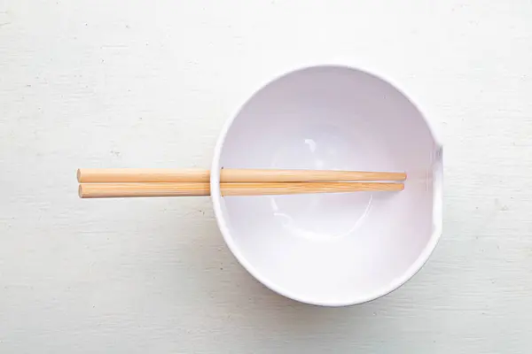 Beyaz yüzeyinde çubuklar olan minimalist kase. Yüksek kalite fotoğraf