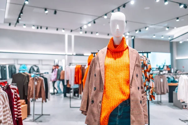 stock image Mannequin dressed in a bright warm orange sweater, plaid jacket casual wear in a mall store. Shopping store. Gdansk, Poland, Europe.