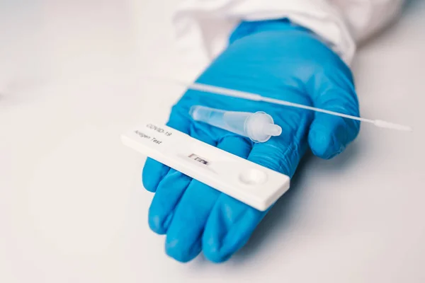 stock image Doctor with surgical mask holding a blood sample. Researchers are inventing vaccines to treat COVID-19 virus. 