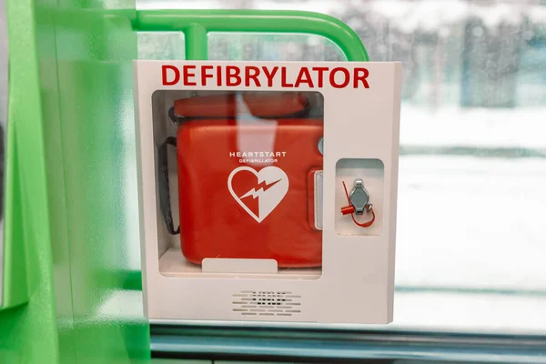 Automated External Defibrillator in white box on the wall Is an emergency pacemaker device for people with cardiac arrest. Heart defibrillator at the train