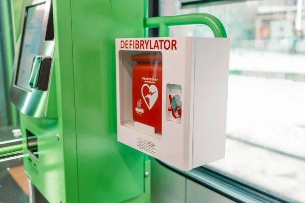 Automated External Defibrillator in white box on the wall Is an emergency pacemaker device for people with cardiac arrest. Heart defibrillator at the train