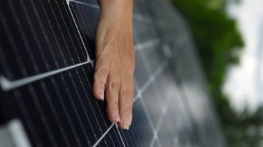 Close up of young engineer hand is checking the operation of sun and cleanliness of photovoltaic solar panels. Concept.renewable energy, technology, electricity, service, green, future. 