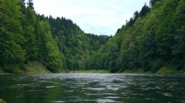 Beautiful natural scenery of Dunajec river in Pieniny mountains green forest with mountains in background. Poland 