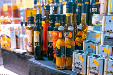 BARCELONA, SPAIN - October 14, 2022: Bottles of fresh olive oil on street market closeup with selective focus