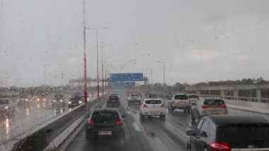 Vienna, Austria February 13, 2023: in the car to drive in heavy rain, wipers clean the windshield glass. 4k footage