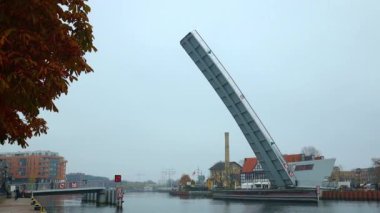 GDANSK, POLAND - October 31, 2022: A scenic view of the Motlawa river with a New bascule bridge and ferris wheel in Gdansk, Poland