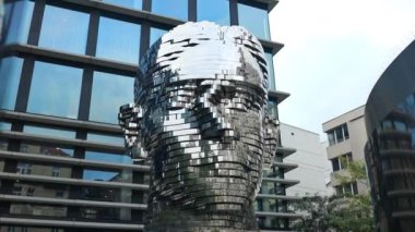 Prague, Czech Republic - September 15, 2022: city view of the Head of Franz Kafka, aka Statue of Kafka, an outdoor sculpture depicting the famous bohemian writer in Prague, Czech Republic. 