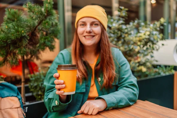 stock image Lifestyle portrait of a young stylish woman with coffee cup at city cafe 