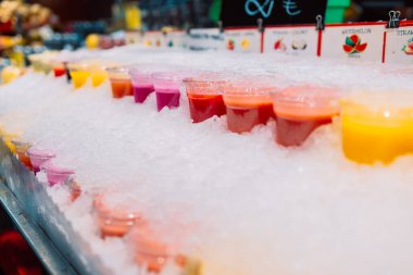 Renkli tropikal meyve suyu, market tezgahında buzlu taze soğuk içecekler, yakın plan fotoğraf. Yüksek kalite fotoğraf