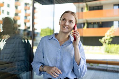 Young elegant professional leader Caucasian woman, female executive retail manager supervisor, small business owner wearing suit holding digital tablet standing outdoor looking at camera, portrait.