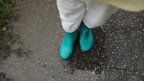 Woman Wearing Rain Rubber Boots Walking Running Jumping Puddle Water — Stock Video