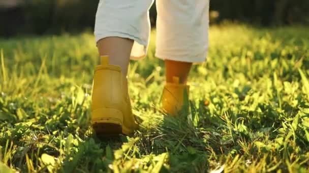 Vista Posterior Los Pies Mujer Agricultora Botas Amarillas Camina Través — Vídeos de Stock