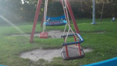 Oyun alanı salıncağı. Çocuklar parkta sallanıyor. Yüksek kaliteli FullHD görüntüler