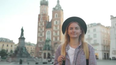 Krakow 'daki eski Pazar Meydanı' nda elinde turist haritası olan gezgin bir kadının gerçek görüntüsü. Seyahat ve aktif yaşam tarzı konsepti. Yüksek kalite fotoğraf. Yüksek kaliteli FullHD görüntüler