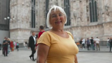 Milano 'daki ünlü Duomo katedralinin önünde selfie çeken kıdemli mutlu turist. Milan 'da iyi tatiller. Yüksek kaliteli FullHD görüntüler