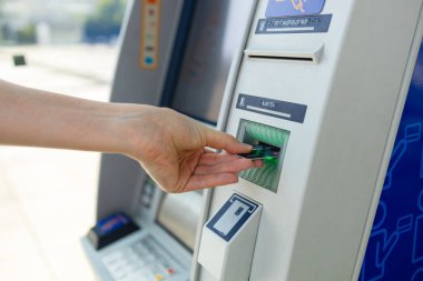 Para çekerken kredi kartı ve ATM kullanan genç bir kadın. Yüksek kalite fotoğraf