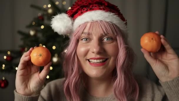 2024 Woman Holding Two Sweet Mandarins Standing Christmas Tree Background — Stock Video