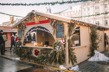 Selling traditional hot fast street food at the Christmas Fair on the central square of the city, the market, the European city for Christmas. High quality photo clipart