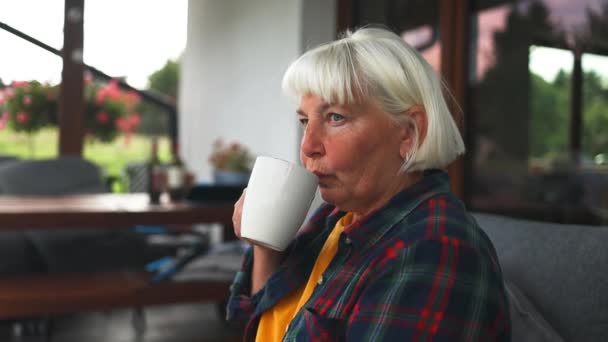 Lonely Brooding Caucasian 60S Senior Woman Having Cup Tea Cozy — Stock Video